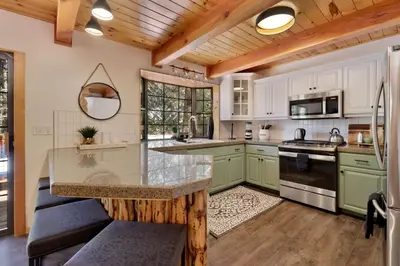 a kitchen with green cabinets and a wooden ceiling at Dreams of Summit-1120 by Big Bear Vacations in Big Bear Lake