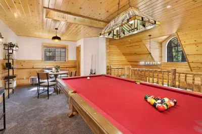 a pool table in a room with wooden walls at Dreams of Summit-1120 by Big Bear Vacations in Big Bear Lake