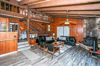 a living room with leather furniture and a fireplace at Lakeview Fishing House-121 by Big Bear Vacations in Big Bear Lake