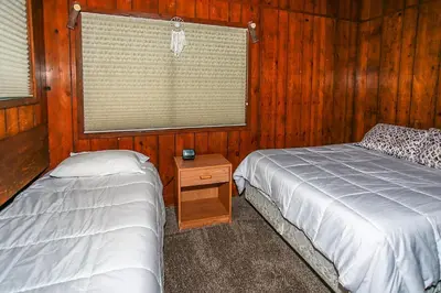 a bedroom with two twin beds and a window at Lakeview Fishing House-121 by Big Bear Vacations in Big Bear Lake