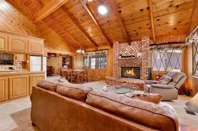 a living room with a couch and a fireplace at Moose Creek Chalet-1237 by Big Bear Vacations in Big Bear Lake