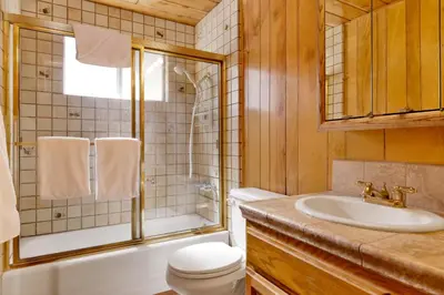 a bathroom with a tub and a sink and a toilet at Moose Creek Chalet-1237 by Big Bear Vacations in Big Bear Lake