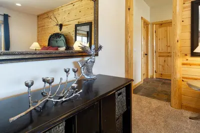 a room with a mirror on the wall and a table at Eagle Ridge Views-1648 by Big Bear Vacations in Big Bear Lake