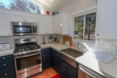 a kitchen with a sink and a stove top oven at Mountain Modern-1743 by Big Bear Vacations in Big Bear Lake