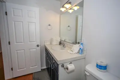 a bathroom with a sink and a mirror and a toilet at Mountain Modern-1743 by Big Bear Vacations in Big Bear Lake