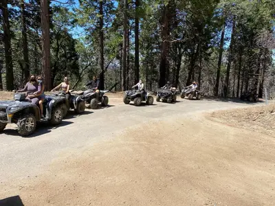 a group of people riding atvs down a dirt road at Sequoia National Forest CabinG in Panorama Heights