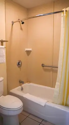 a bathroom with a tub and a toilet and a shower at Country Inn Ontario in Ontario