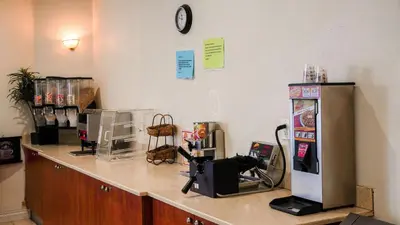 a counter in a store with a cash register and a refrigerator at Country Inn Ontario in Ontario