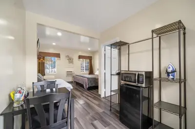 a living room with a kitchen and a bedroom at 24 Hours Motel in Los Angeles