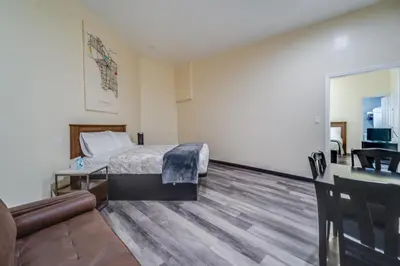 a hotel room with a bed and a living room at 24 Hours Motel in Los Angeles