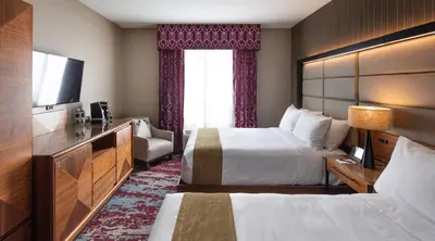 a hotel room with two beds and a television at Bear Springs Hotel in Highland