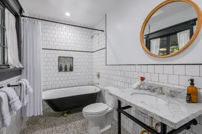 a bathroom with a tub and a toilet and a sink at The Venice Beach House in Los Angeles