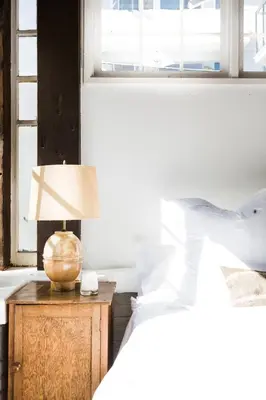 a bedroom with a bed and a lamp on a nightstand at The Venice Beach House in Los Angeles