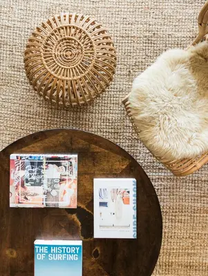 a pile of objects on the floor with magazines and a basket at The Venice Beach House in Los Angeles