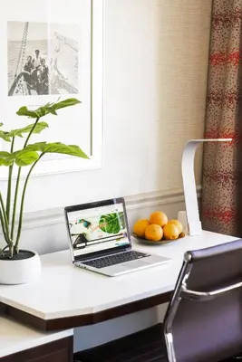 a laptop computer sitting on a desk with oranges at ALO Hotel by Ayres, Orange in Anaheim