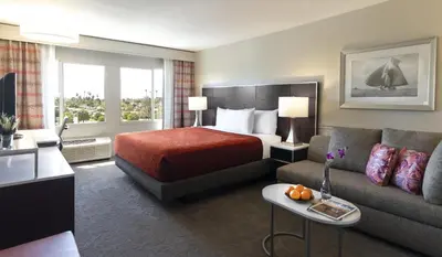 a hotel room with a bed and a couch at ALO Hotel by Ayres, Orange in Anaheim