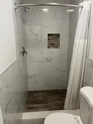 a bathroom with a shower and a toilet at Griffith Park Motel, in Los Angeles Hollywood Area in Glendale