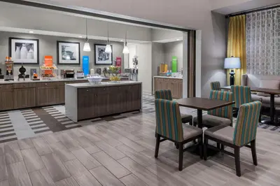 a kitchen and dining room with a table and chairs at Hampton Inn & Suites Los Angeles/Hollywood, CA in Los Angeles