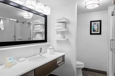 a white bathroom with a sink and a mirror at Hampton Inn & Suites Los Angeles/Hollywood, CA in Los Angeles