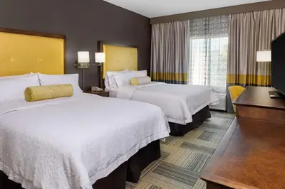 a hotel room with two beds and a television at Hampton Inn & Suites Los Angeles/Hollywood, CA in Los Angeles