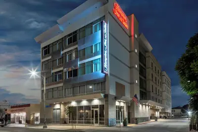 a hotel building with a neon sign on it at Hampton Inn & Suites Los Angeles/Hollywood, CA in Los Angeles
