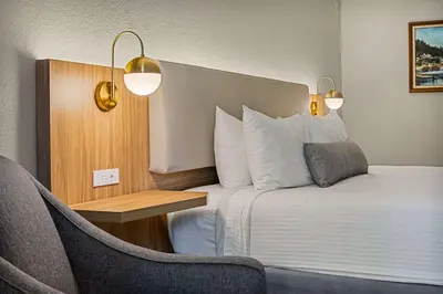 a hotel room with a bed and a chair at Chateau Big Bear Boutique Hotel, BW Signature Collection in Big Bear Lake