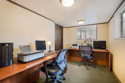 an office with a desk with two computers and two chairs at Chateau Big Bear Boutique Hotel, BW Signature Collection in Big Bear Lake