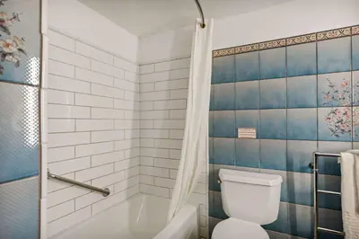 a bathroom with a tub and a toilet and a shower at Chateau Big Bear Boutique Hotel, BW Signature Collection in Big Bear Lake
