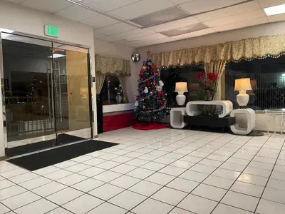 a room with a christmas tree in a building at Grand Inn in Fullerton