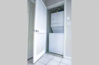a laundry room with a white washer and dryer at Amazing Apartments near the grove in Los Angeles