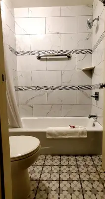 a bathroom with a tub and a toilet and a sink at Triplodge of Santa Clarita in Santa Clarita