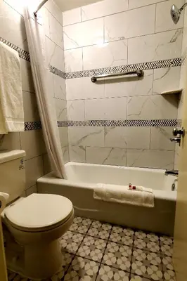 a bathroom with a toilet and a bath tub at Triplodge of Santa Clarita in Santa Clarita
