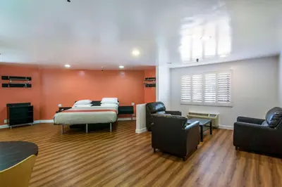 a hospital room with two beds and two chairs at Motel 6 Monterey Park in Monterey Park