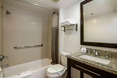 a bathroom with a sink and a toilet and a mirror at Motel 6 Monterey Park in Monterey Park