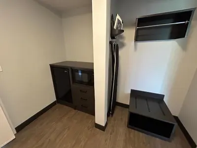 a room with a tv and a table and a desk at Studio 6 Suites Gardena, CA in Gardena