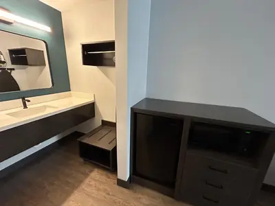 a bathroom with a sink and a mirror at Studio 6 Suites Gardena, CA in Gardena