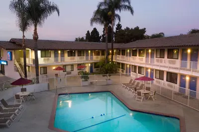 a hotel with a swimming pool in front of a building at Motel 6-Camarillo, CA in Camarillo