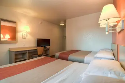a hotel room with two beds and a desk at Motel 6-Westminster, CA - South - Long Beach Area in Westminster