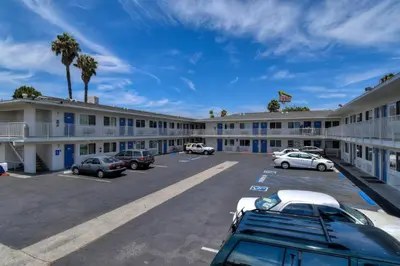 a hotel with cars parked in a parking lot at Motel 6-Westminster, CA - South - Long Beach Area in Westminster