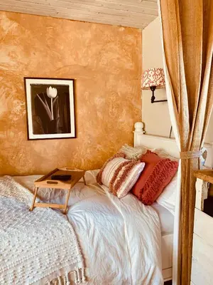 a bedroom with a bed with a table on it at Under the Tuscan Sun Cottage in West Los Angeles in Los Angeles