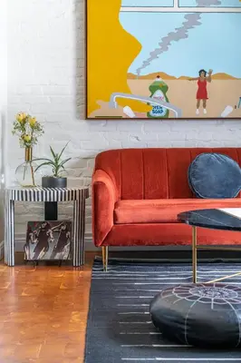 a living room with a red couch and a painting at Gold-Diggers in Los Angeles