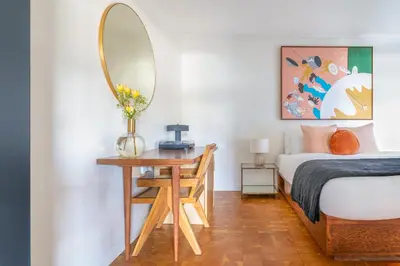 a bedroom with a bed and a table with a mirror at Gold-Diggers in Los Angeles