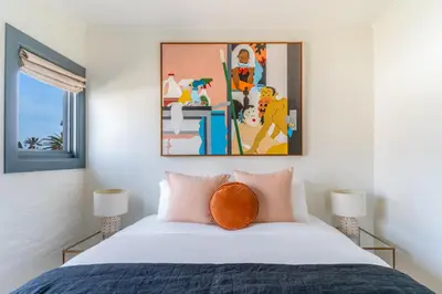 a bedroom with a bed with a painting above it at Gold-Diggers in Los Angeles
