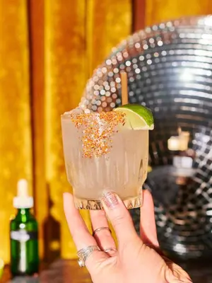 a person holding a drink with a lime on top at Gold-Diggers in Los Angeles