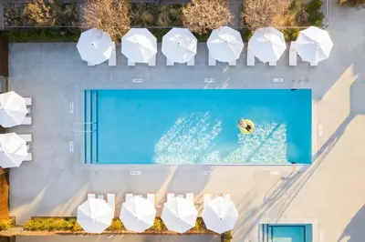 an overhead view of a swimming pool with white umbrellas at Cuyama Buckhorn in New Cuyama