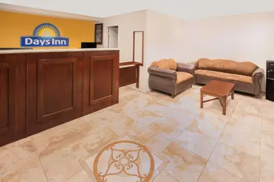 a waiting area of a days inn with couches and chairs at Days Inn by Wyndham Ontario Airport in Ontario