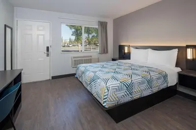 a hotel room with a bed and a window at Motel 6-Fontana, CA in Fontana