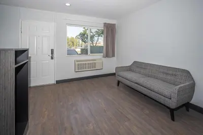 a living room with a couch and a window at Motel 6-Fontana, CA in Fontana