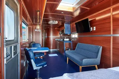a train room with a blue chair and a table at Waypoint Ventura in Ventura