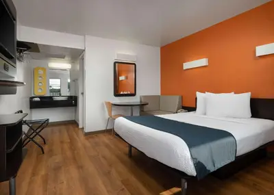 a hotel room with a large bed and a table at Motel 6-Carpinteria, CA - Santa Barbara - North in Carpinteria